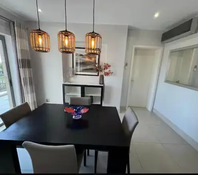 a dining room with a black table and chairs at Pine Hills Vilamoura in Quarteira