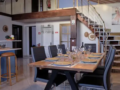 a wooden table with wine glasses and a staircase at Casa Da Liberdade
