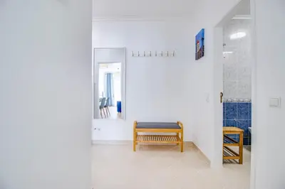 a hallway with a bench and a mirror at Charming Old Town 1BR 50m from Beach AC Wi-Fi Parking in Albufeira