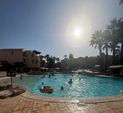 a group of people swimming in a swimming pool at FourSeasons Vilamoura in Quarteira