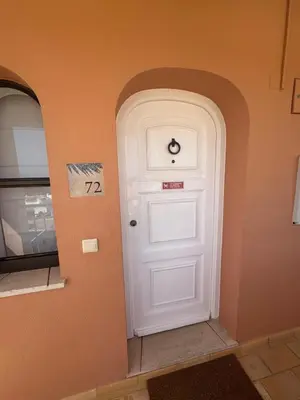 a white door in the corner of a room at FourSeasons Vilamoura in Quarteira