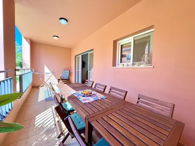 a dining room with a table and chairs on a balcony at Vilamoura Victoria Boulevard With Pool by Homing in Vilamoura