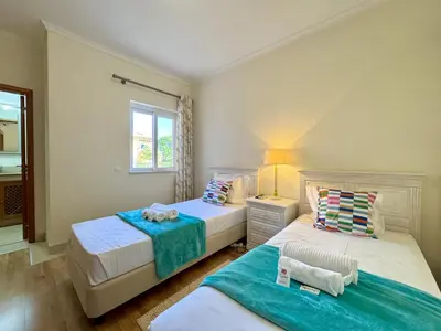 a bedroom with two beds and a window at Vilamoura Victoria Boulevard With Pool by Homing in Vilamoura