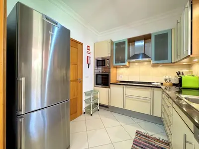 a large kitchen with a stainless steel refrigerator at Vilamoura Victoria Boulevard With Pool by Homing in Vilamoura