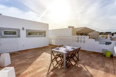 a dining room with a table and a balcony at Blife Galya private house in Faro