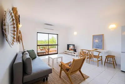 a living room with a couch and chairs and a table at Stunning Apartment By Dreamplaces in Albufeira