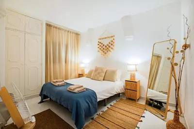 a bedroom with a white bed and a mirror at Stunning Apartment By Dreamplaces in Albufeira