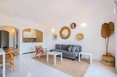 a living room with a couch and a table at Stunning Apartment By Dreamplaces in Albufeira