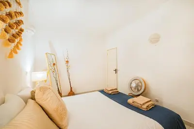 a bedroom with a bed and a clock on the wall at Stunning Apartment By Dreamplaces in Albufeira