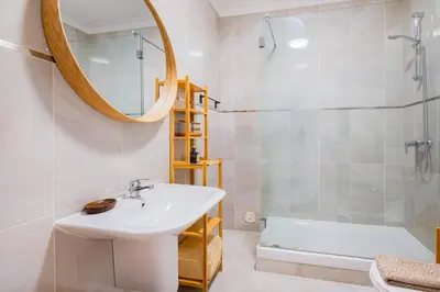 a bathroom with a sink and a shower and a mirror at Stunning Apartment By Dreamplaces in Albufeira