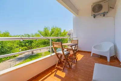 a balcony with a table and chairs and a view at Stunning Apartment By Dreamplaces in Albufeira