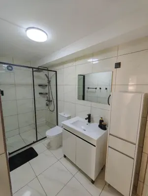 a bathroom with a shower and a sink and a toilet at Santos Studio in Faro
