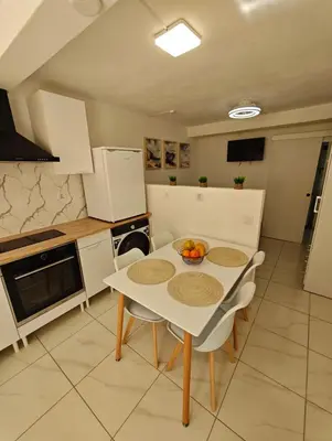 a kitchen with a table with a bowl of fruit on it at Santos Studio in Faro