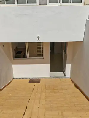 an empty room with a white ceiling and a wooden floor at Santos Studio in Faro