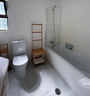 a bathroom with a toilet and a shower and a sink at Lemon Beach House - São Rafael in Albufeira