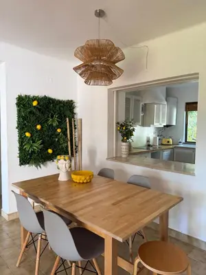 a dining room with a wooden table and chairs at Lemon Beach House - São Rafael in Albufeira