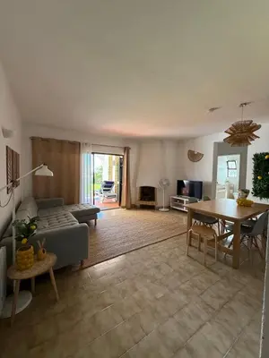 a living room with a couch and a table at Lemon Beach House - São Rafael in Albufeira
