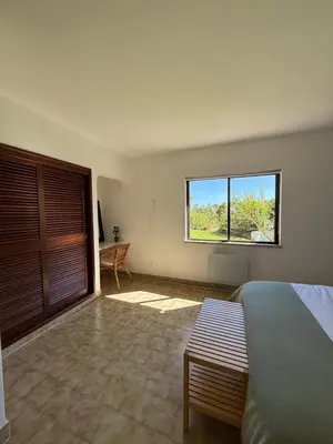 a bedroom with a bed and a large window at Lemon Beach House - São Rafael in Albufeira