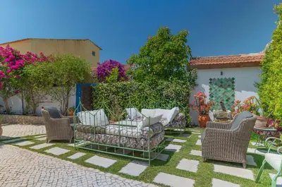 a patio with wicker furniture in a yard at Perfect To Relax in Algoz