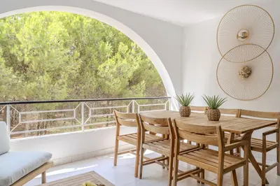 a dining room with a table and chairs and a large window at #335 Recanto do Manaca by Home Holidays in Guia