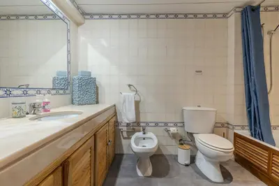 a bathroom with a toilet and a sink at #335 Recanto do Manaca by Home Holidays in Guia