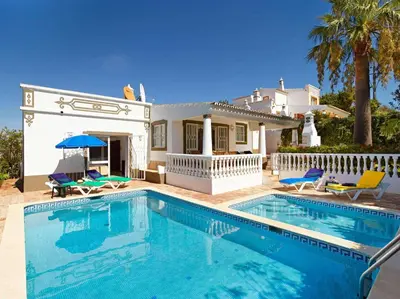 a swimming pool in front of a house at Oliveira by Vintage Travel in Guia