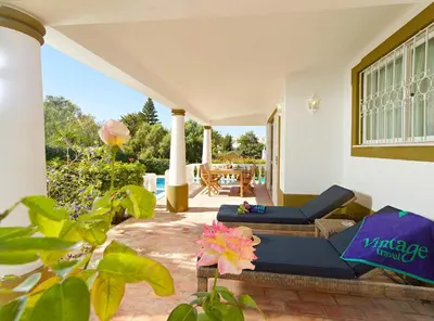 a patio with two couches and a table and flowers at Oliveira by Vintage Travel in Guia