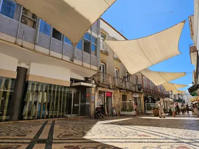 a street in a town with buildings and umbrellas at Blife Portugalya - private rooms at Santantonya 2nd floor in Faro