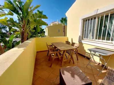 a patio with a table and chairs on a balcony at Vilapeti by SAPvillas in Quarteira