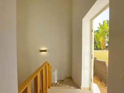 a staircase leading to the second floor of a house at Vilapeti by SAPvillas in Quarteira
