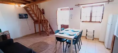 a kitchen with a table and chairs in a room at Quinta do Lagar - 01 in Albufeira