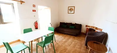 a living room with a table and chairs and a couch at Quinta do Lagar - 02 in Albufeira