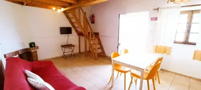a living room with a red couch and a table at Quinta do Lagar - 03 in Albufeira