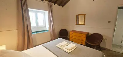 a bedroom with a bed and a dresser and a window at Quinta do Lagar - 04 in Albufeira
