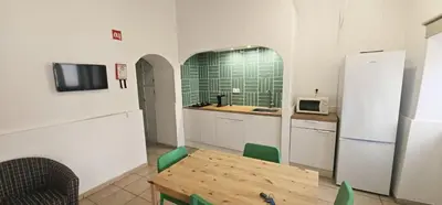 a kitchen with a table and a refrigerator at Quinta do Lagar - 04 in Albufeira
