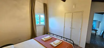 a room with a bed with a table and a window at Quinta do Lagar - 05 in Albufeira