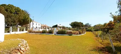 a large yard with a house in the background at Quinta do Lagar - 06 in Albufeira
