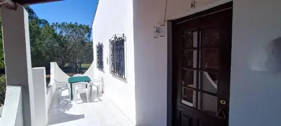 a porch with a door and a green chair at Quinta do Lagar - 08 in Albufeira