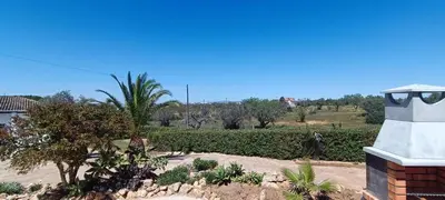 a view of a garden with trees and a building at Quinta do Lagar - 09 in Albufeira