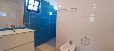 a bathroom with a toilet and a mirror and a sink at Quinta do Lagar - 09 in Albufeira