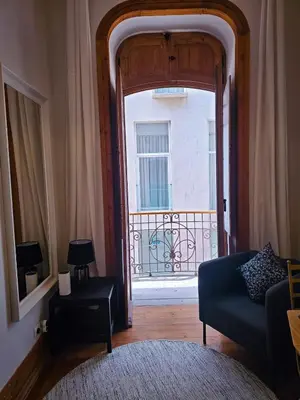 a bedroom with a bed and some framed pictures on the wall at The Central Faro in Faro