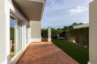 an external view of a house with a patio and grass at V4 Duplex Quinta do Lago Sal in Quinta do Lago