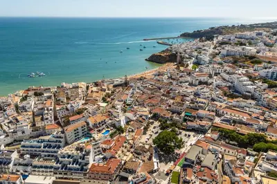 an aerial view of a city and the ocean at Downtown Rooftop 1 Bedroom Apartment in Albufeira