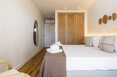 a bedroom with two beds with towels on a table at Casa Alonso 2 Bedroom Apartment with Pool in Albufeira