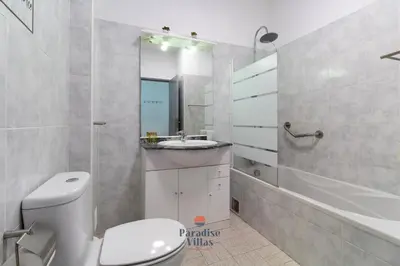 a bathroom with a toilet and a sink and a tub at Cozy 1-Bedroom Apartment, Pool, Central Albufeira in Albufeira