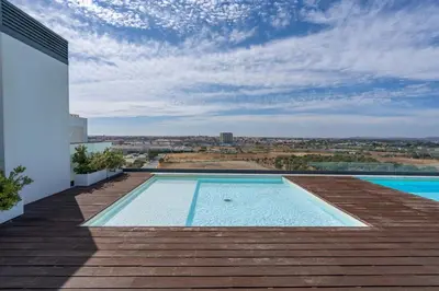a swimming pool on the roof of a house at Rooftop Pools & Balcony Haven by HostWise in Faro