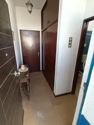 a hallway with a door and a table in a room at Apartamento Alto de Abufeira in Albufeira