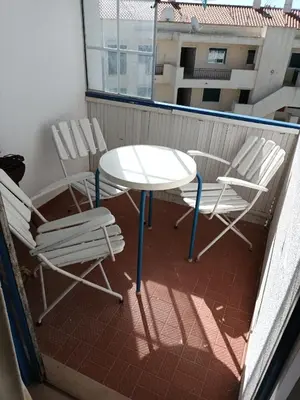 a white table and chairs on a balcony at Apartamento Alto de Abufeira in Albufeira