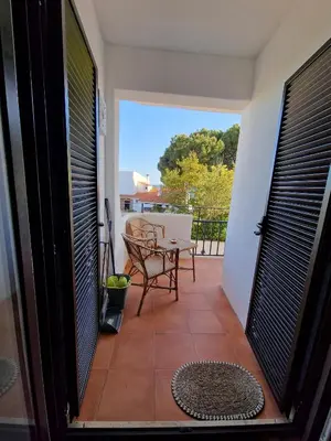 a patio with a table and chairs on a balcony at Incrível T1 na praia da Oura in Albufeira
