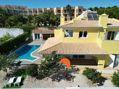 a white bedroom with a bed and a window at #336 Vila Sol by Home Holidays in Sesmarias